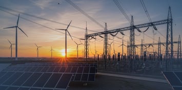 Solar panels, wind turbines and battery storage infrastructure at sunset, illustrating renewable energy projects in Australia and the job opportunities created by large-scale wind, solar and energy storage.